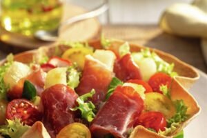 Ensalada con salami crujiente, cebolla y huevo